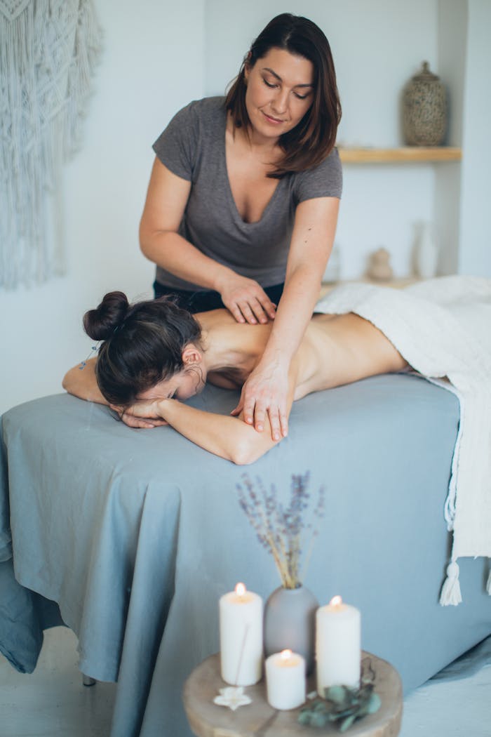 who-we-are A serene spa setting with a therapist giving a back massage to a female client for relaxation.